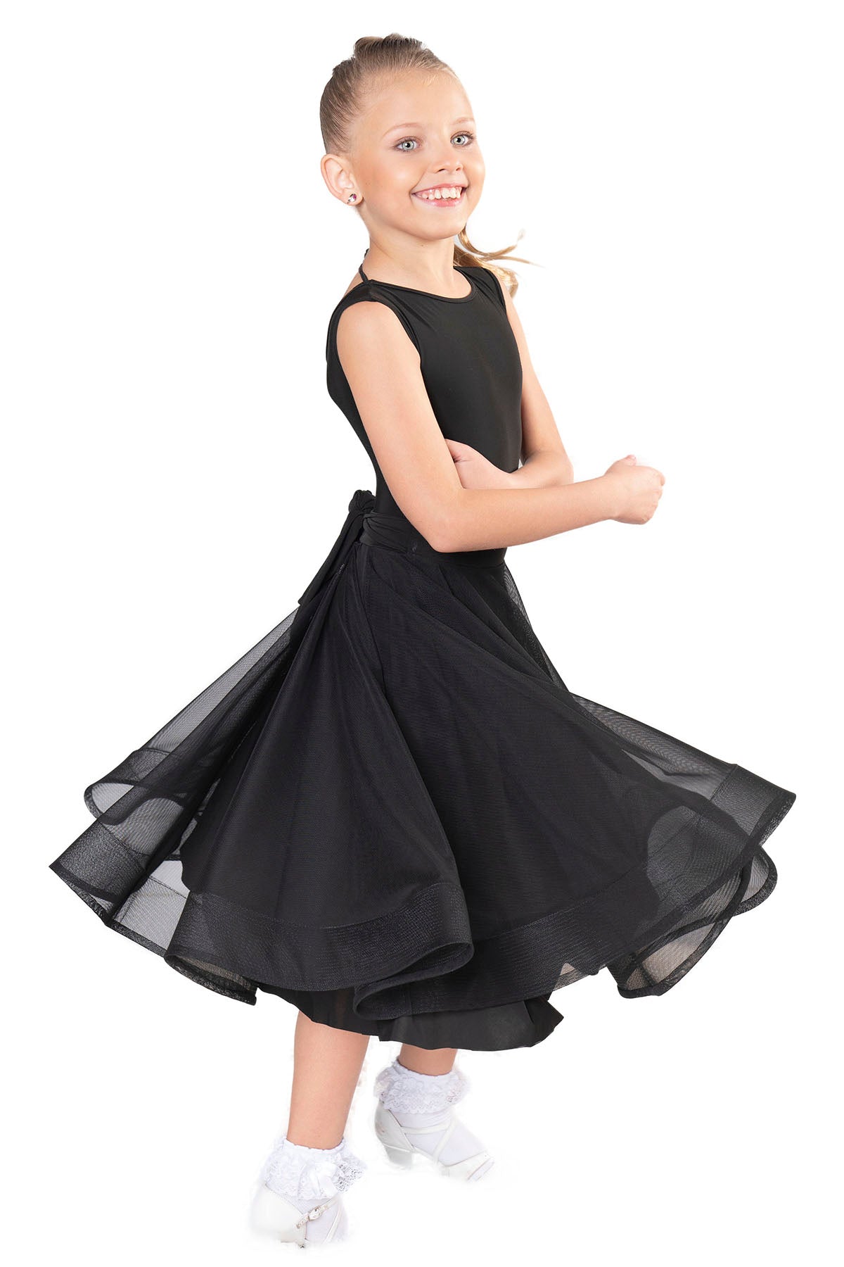 The JR - S2 Girls Mesh Latin Skirt is the perfect addition to any dancer's wardrobe. Made with 95% Poly and 5% Spandex, this skirt is ready to travel without any wrinkles. The mesh and crinoline design adds a touch of elegance to any dance routine. Designed by dancers, for dancers, this skirt can be worn from morning to night, making it suitable for both practice and competition. Order now and receive it within 7-10 business days if not in stock! pictured in black