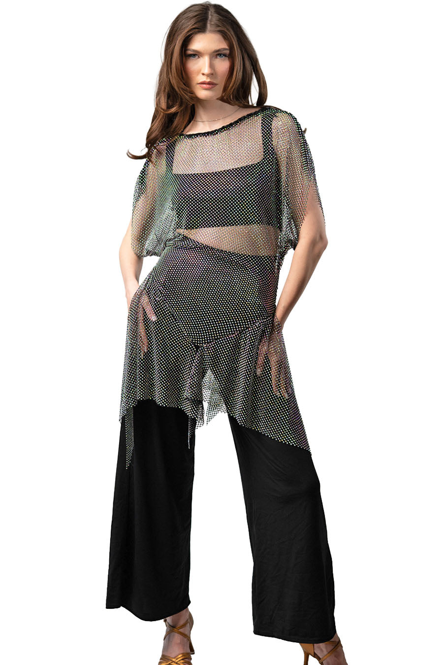 Woman wearing a sheer top and black pants on a white background