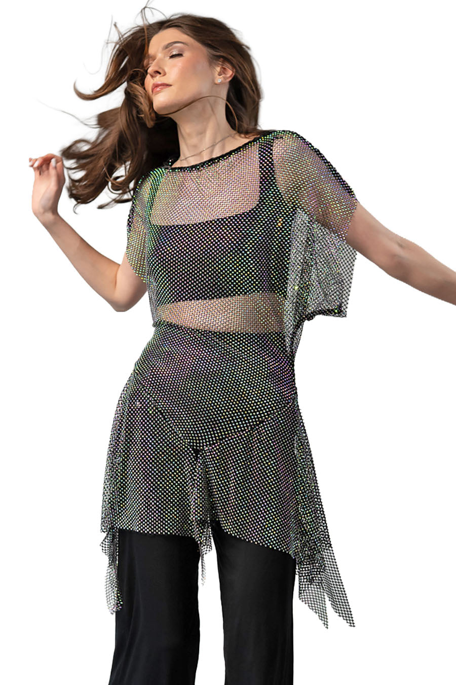 Woman wearing a sheer, rhinestoned top and skirt with black pants on a white background